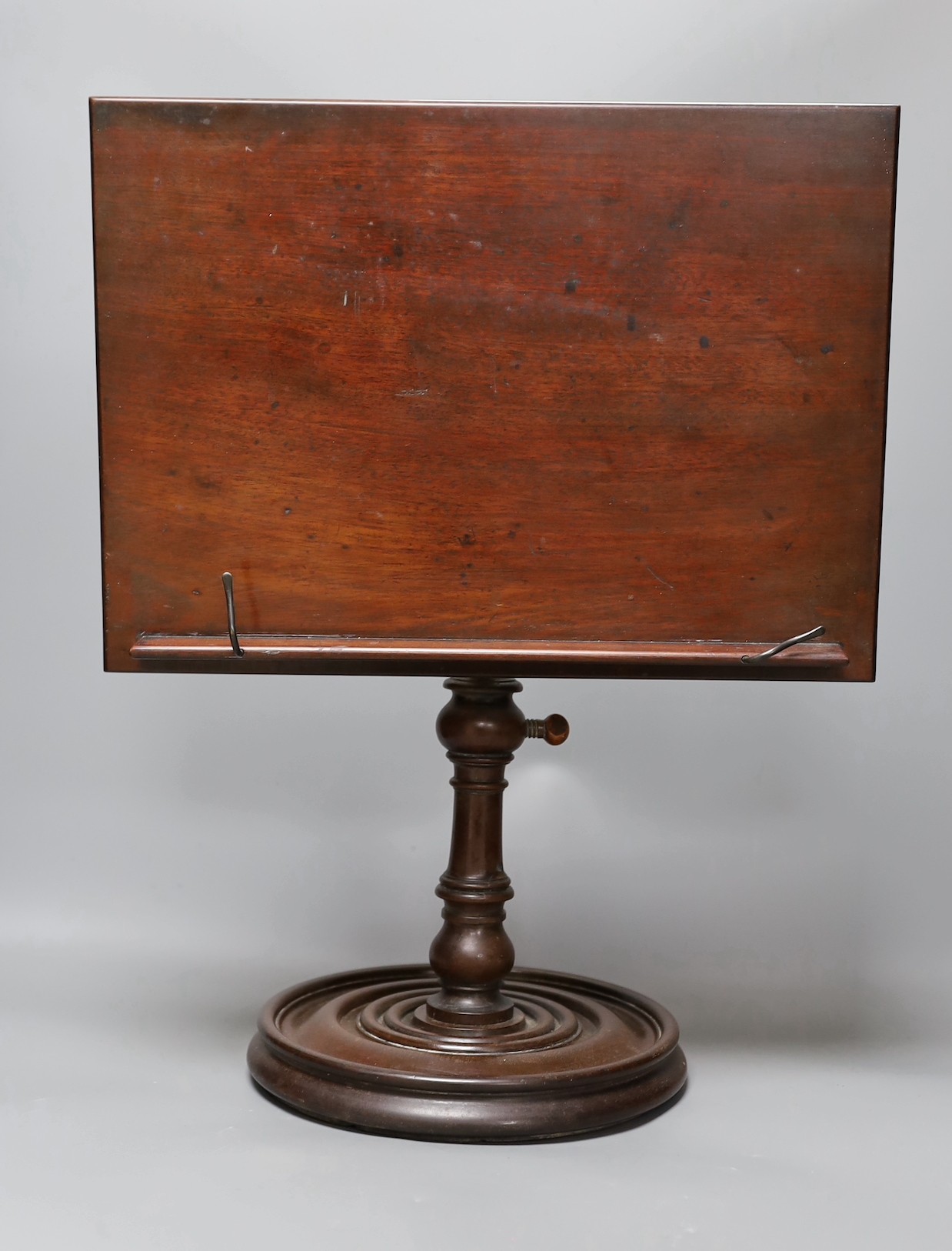 A 19th century turned mahogany book/ music stand, 49 cms high